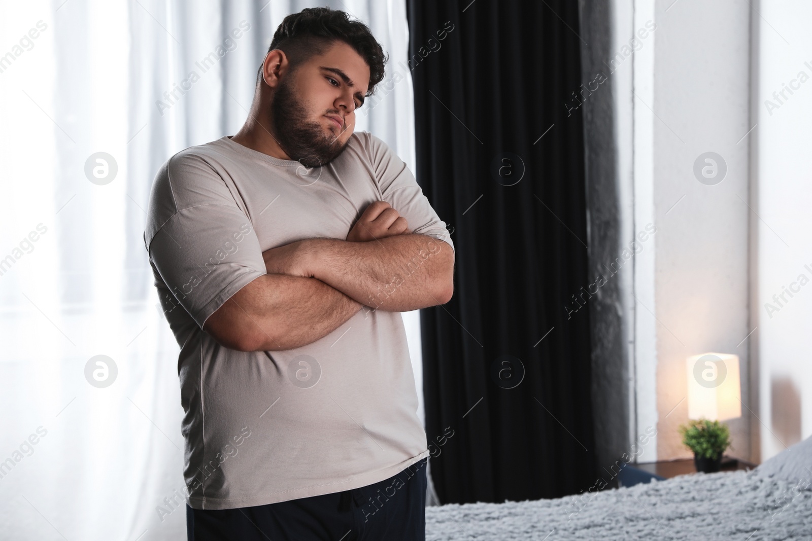 Photo of Overweight man suffering from depression at home