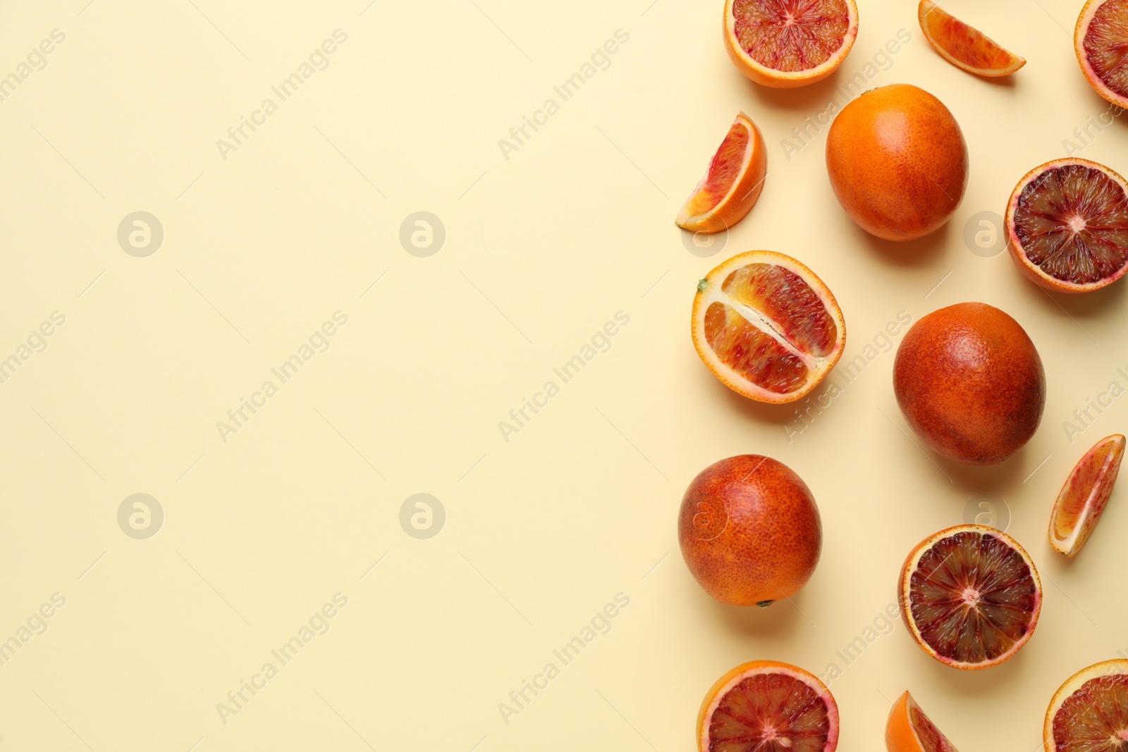 Photo of Many ripe sicilian oranges on beige background, flat lay. Space for text