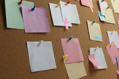 Photo of Colorful paper notes pinned to cork board