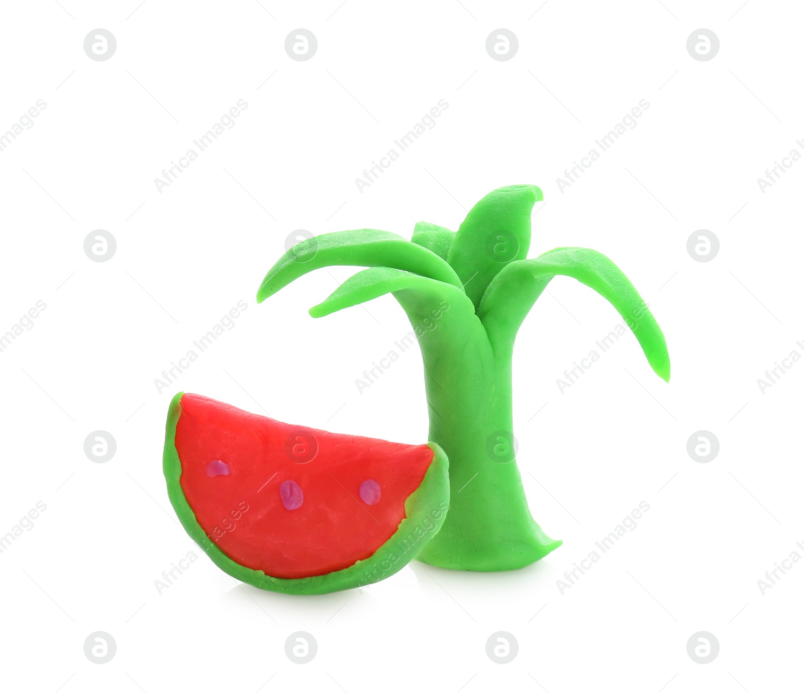 Photo of Small watermelon and tree made from play dough on white background