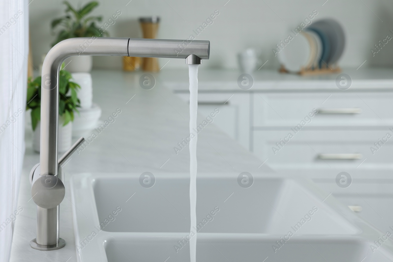 Photo of Stream of water flowing from tap in kitchen, space for text