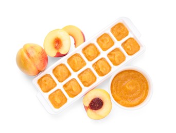 Photo of Nectarine puree in ice cube tray and fresh nectarine fruits isolated on white, top view. Ready for freezing