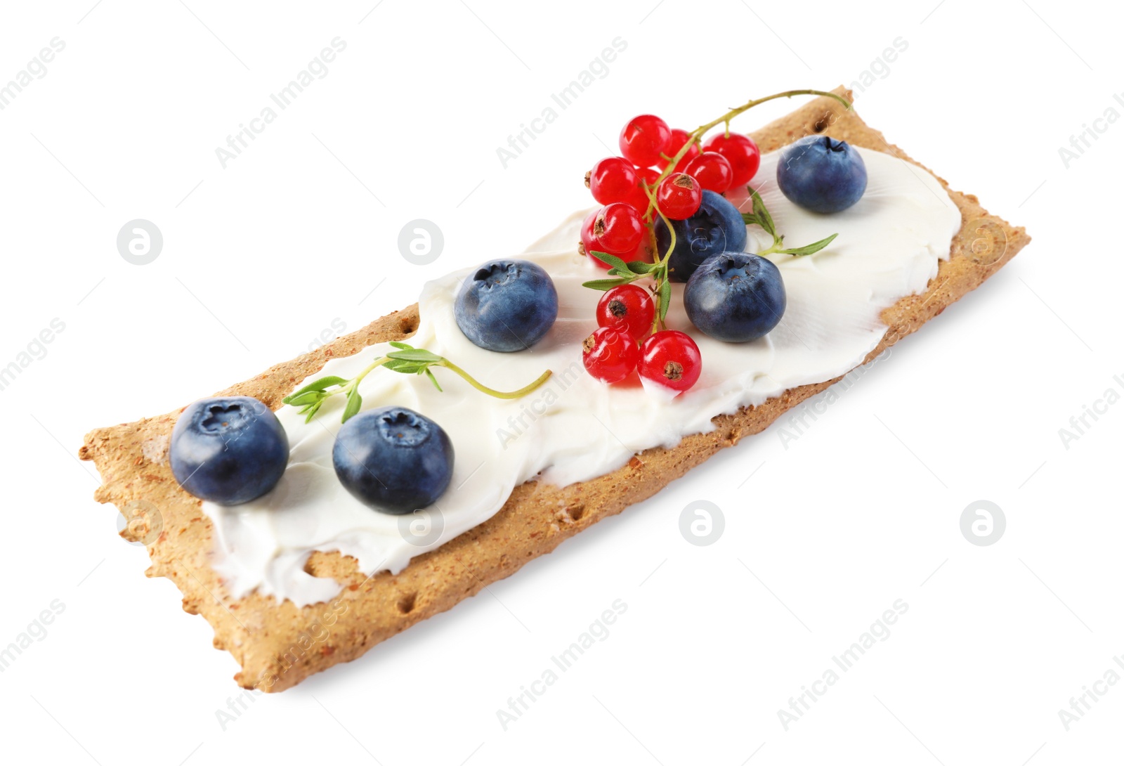 Photo of Tasty crispy cracker with cream cheese, thyme and berries isolated on white