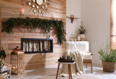 Photo of Beautiful room decorated for Christmas with potted firs. Interior design