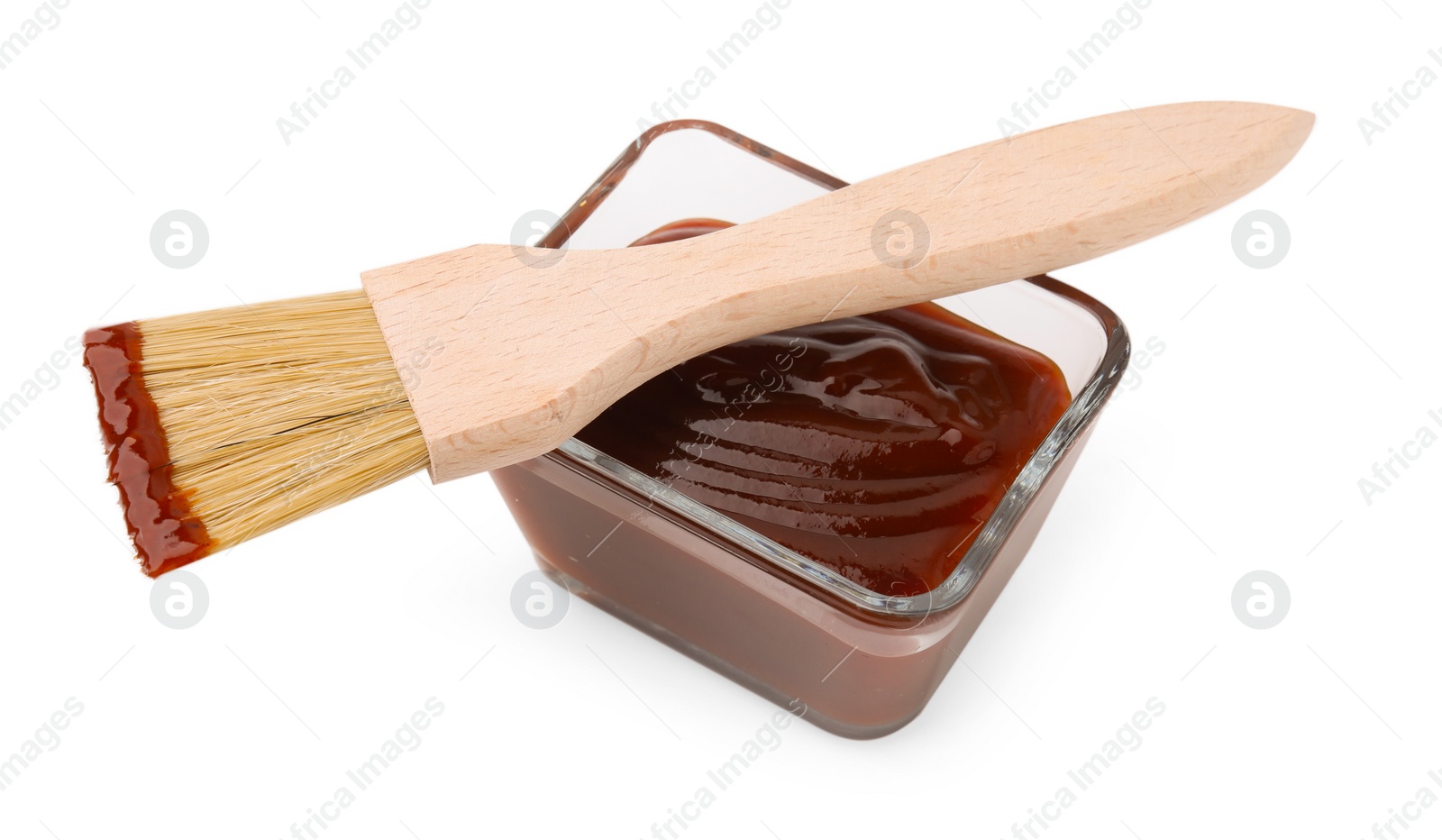 Photo of Marinade in bowl and basting brush isolated on white