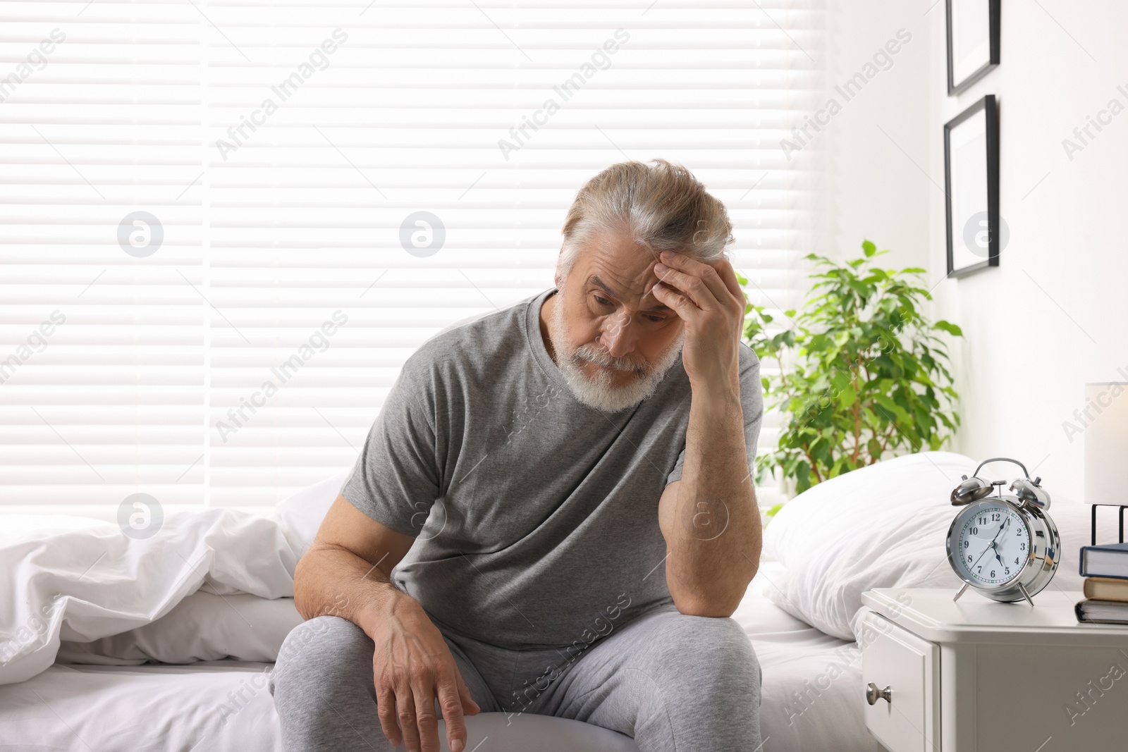 Photo of Sleepy senior man in bed at home