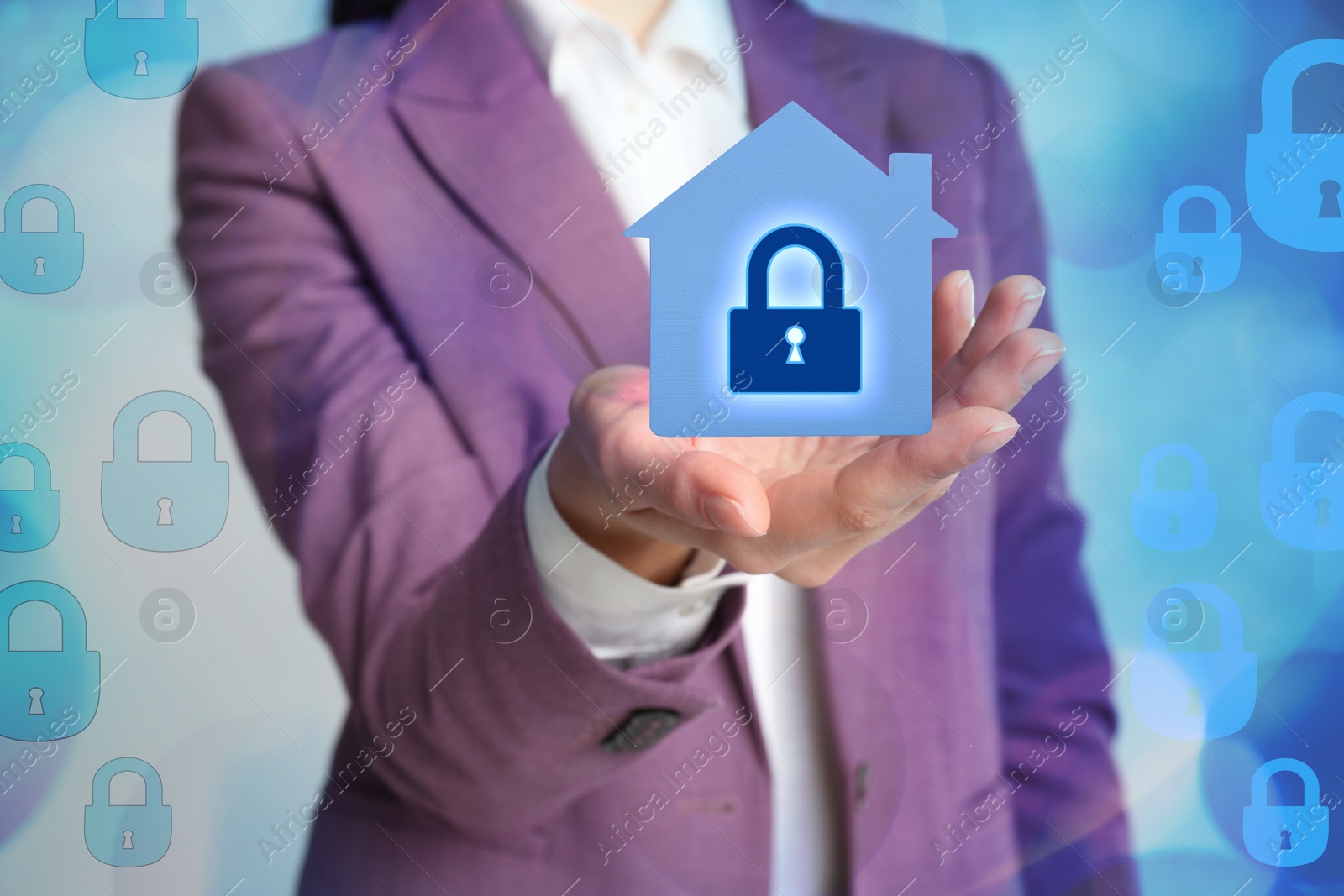 Image of Home security concept. Woman holding house on light background, closeup