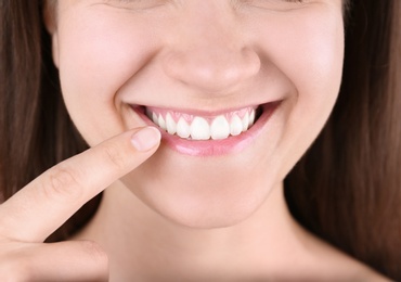 Photo of Young woman with beautiful smile, closeup view