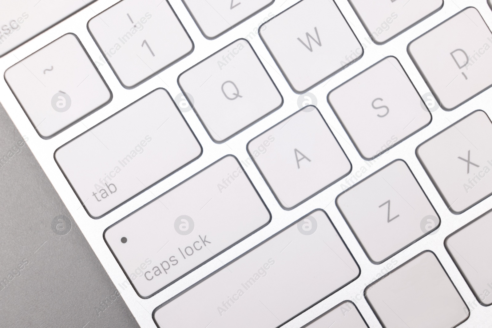 Photo of Internet shopping. Computer keyboard on grey background, top view