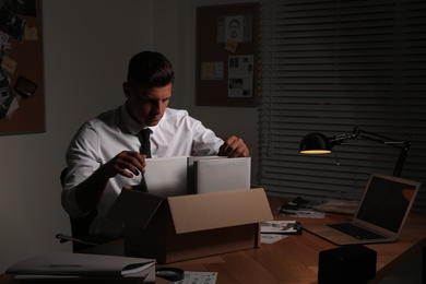 Photo of Professional detective doing paperwork in his office