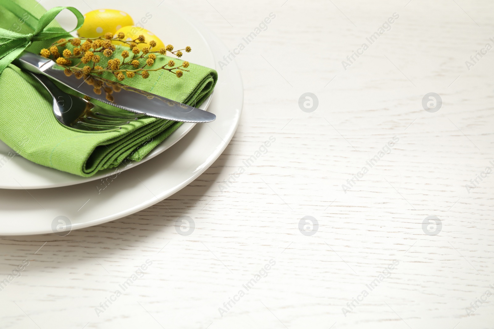 Photo of Festive Easter table setting with beautiful mimosa flowers. Space for text