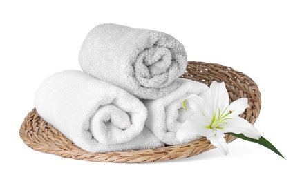 Photo of Wicker tray with towels and flower isolated on white. Spa treatment