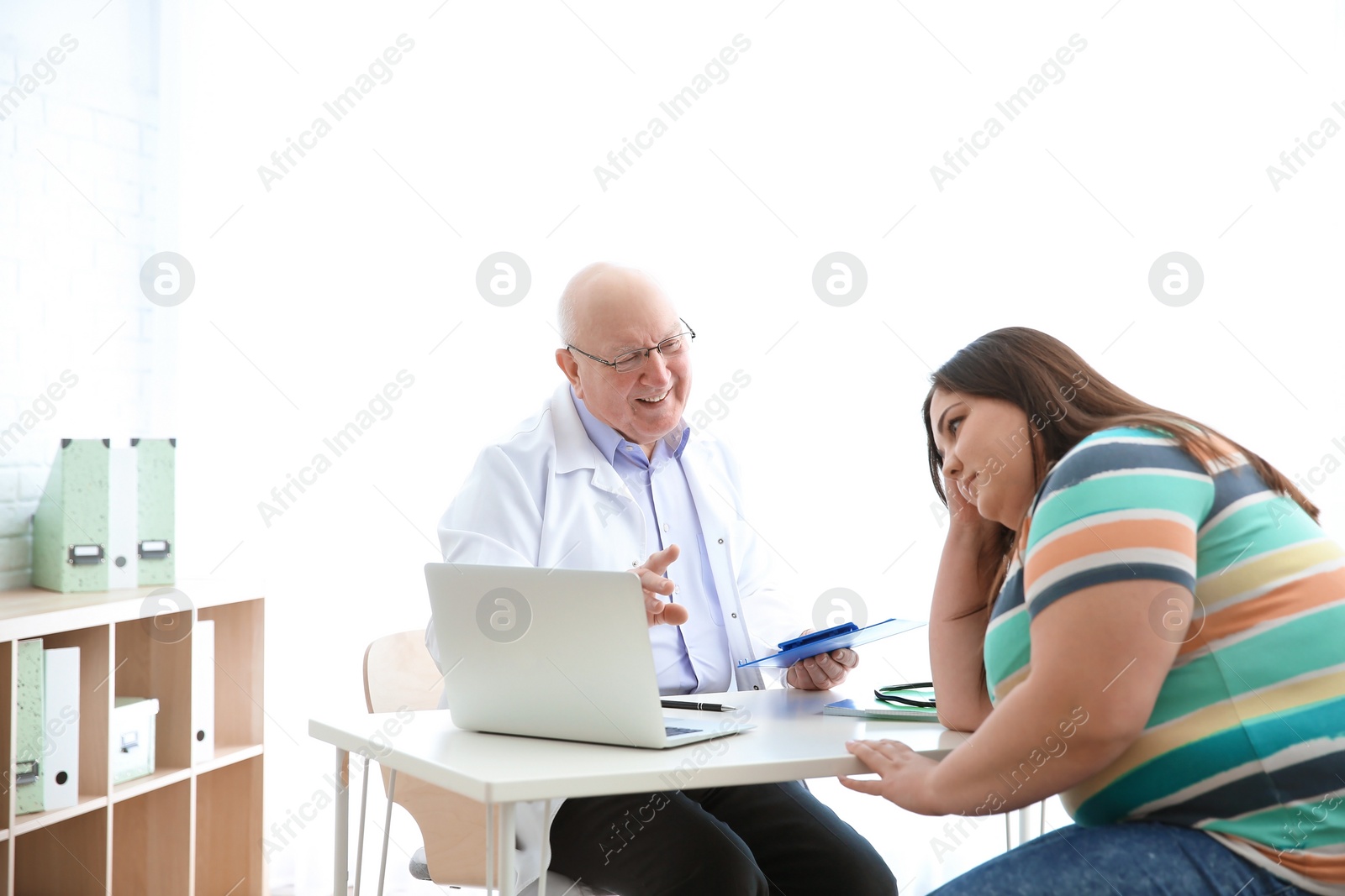 Photo of Overweight woman having consultation at doctor's office