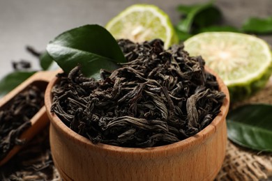 Photo of Dry bergamot tea leaves in wooden bowl, closeup