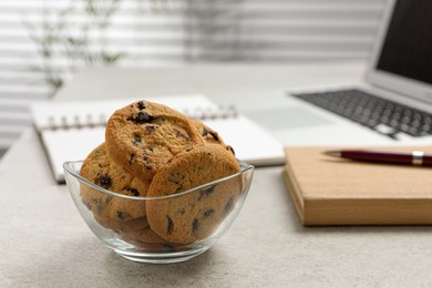 Photo of Chocolate chip cookies on light gray table in office