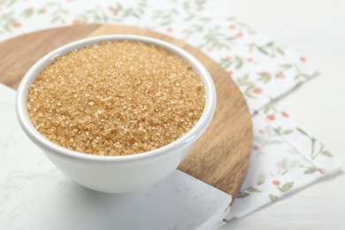 Photo of Brown sugar in bowl on table, closeup