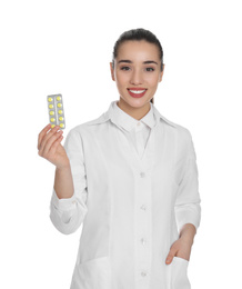 Photo of Professional pharmacist with pills on white background