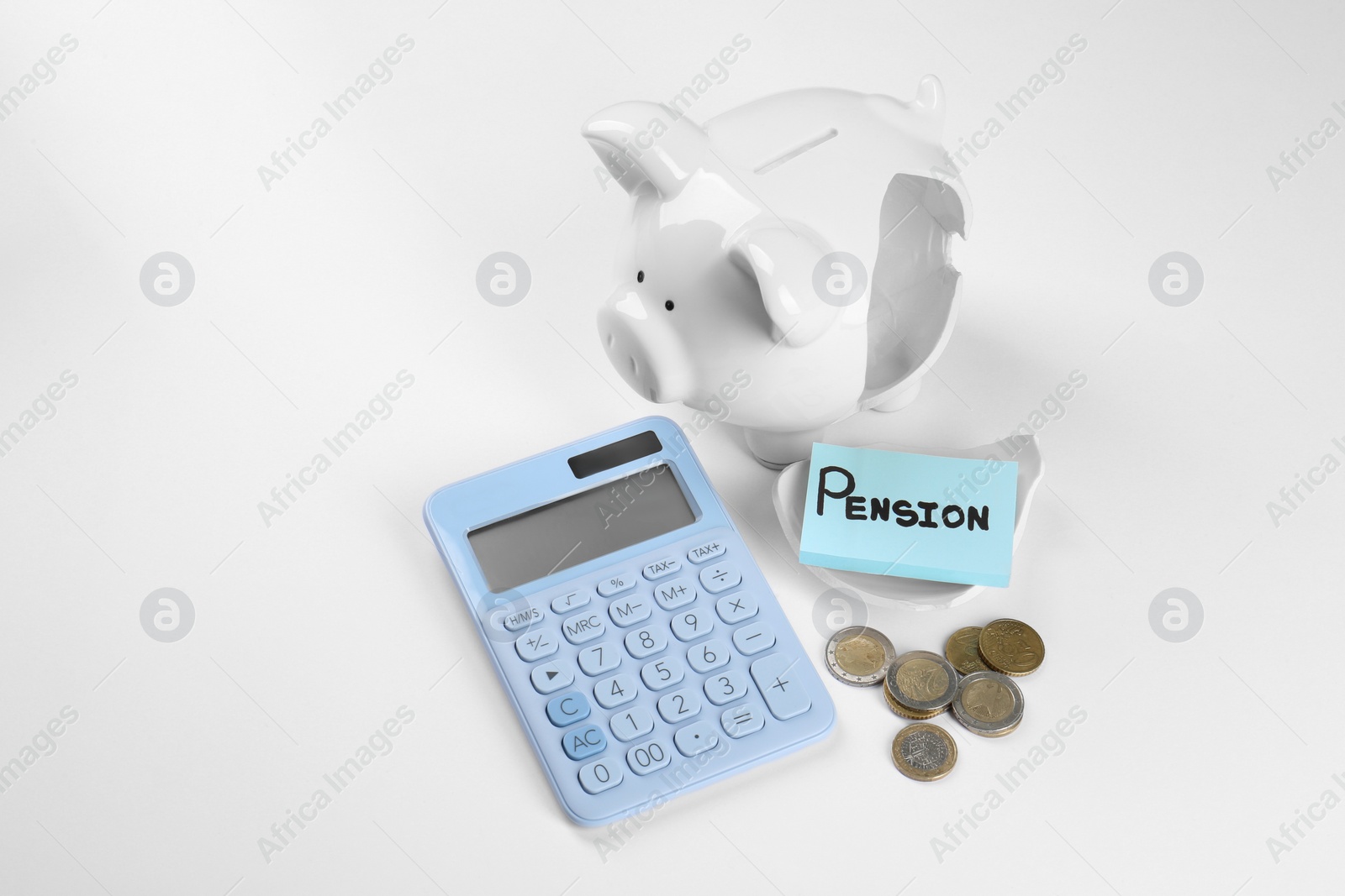 Photo of Calculator, card with word Pension, broken piggy bank and coins on white background. Retirement concept