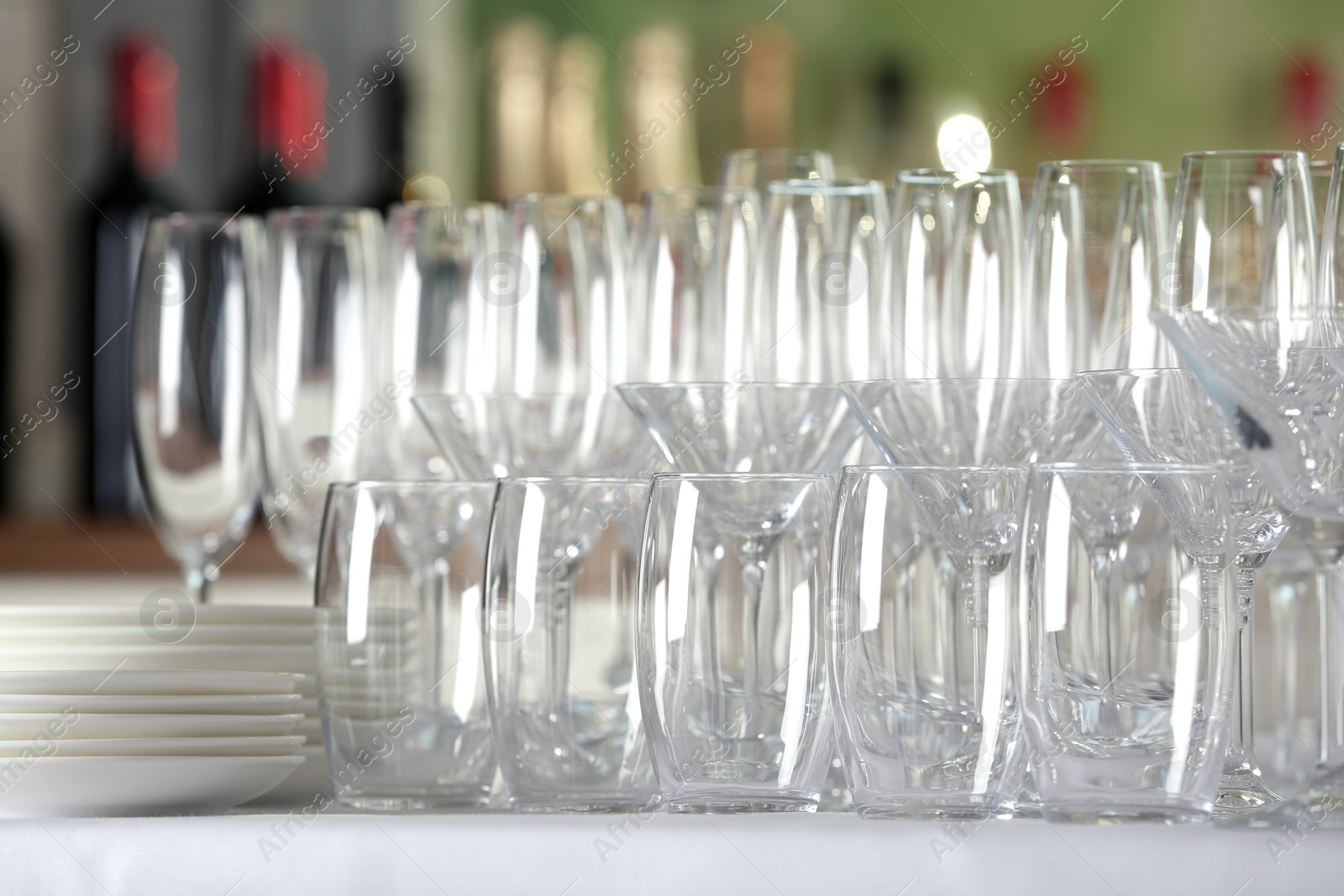 Photo of Set of empty glasses and dishware on table indoors