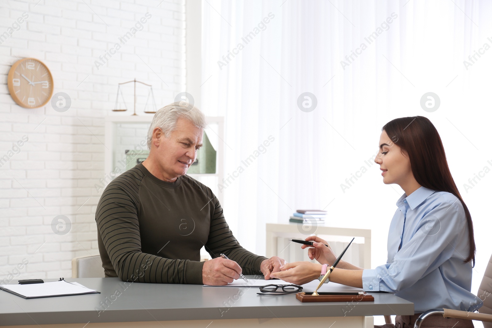 Photo of Lawyer having meeting with client in office