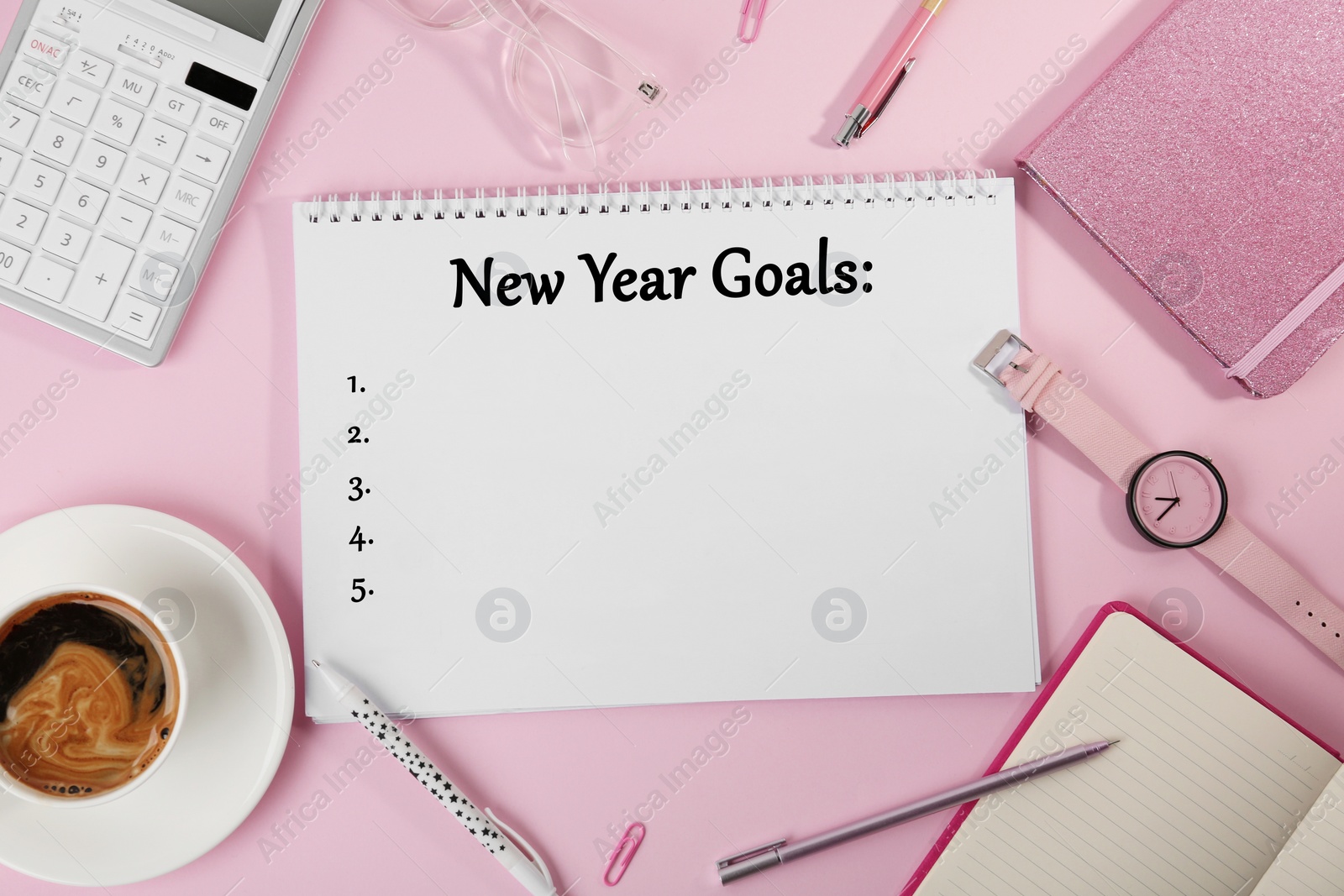 Image of Inscription New Year Goals written in notebook and different objects on pink background, flat lay