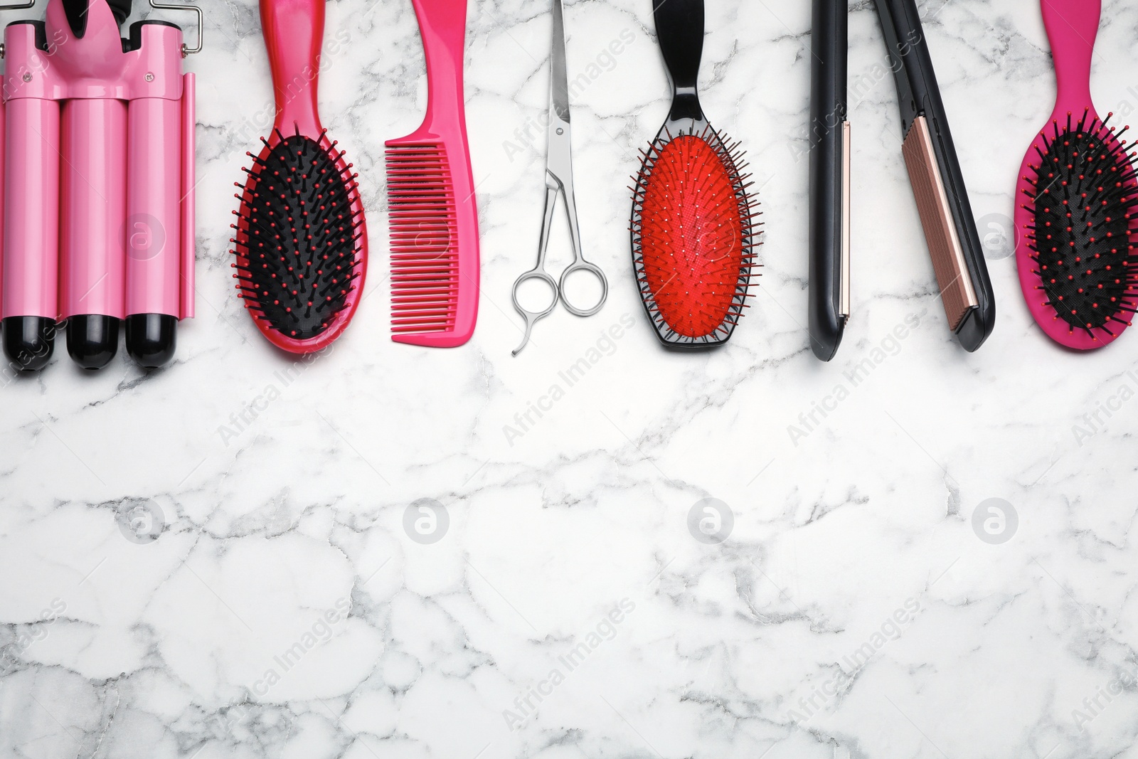 Photo of Flat lay composition of professional hairdresser tools on white marble table, space for text