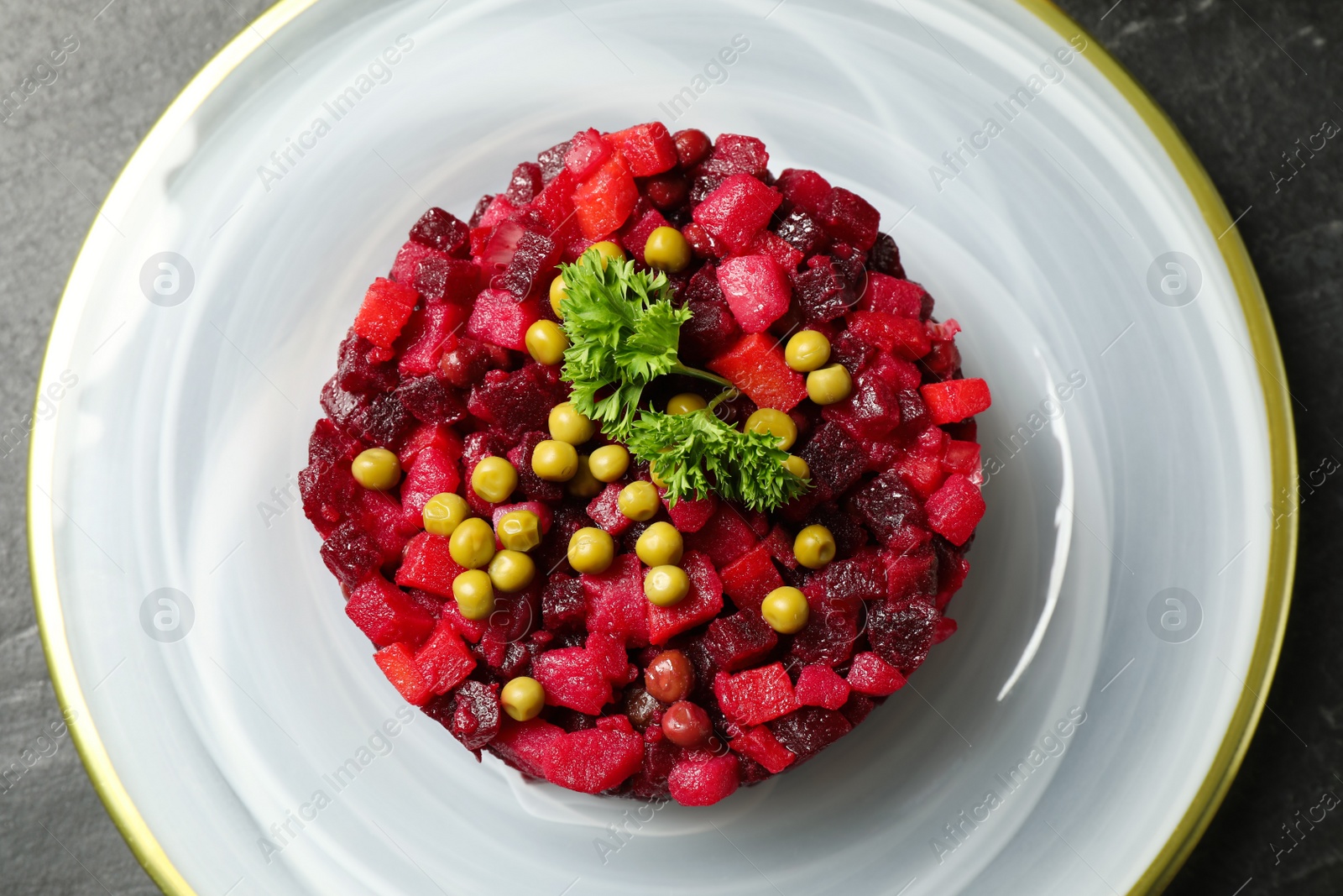 Photo of Traditional Russian salad vinaigrette on plate, top view