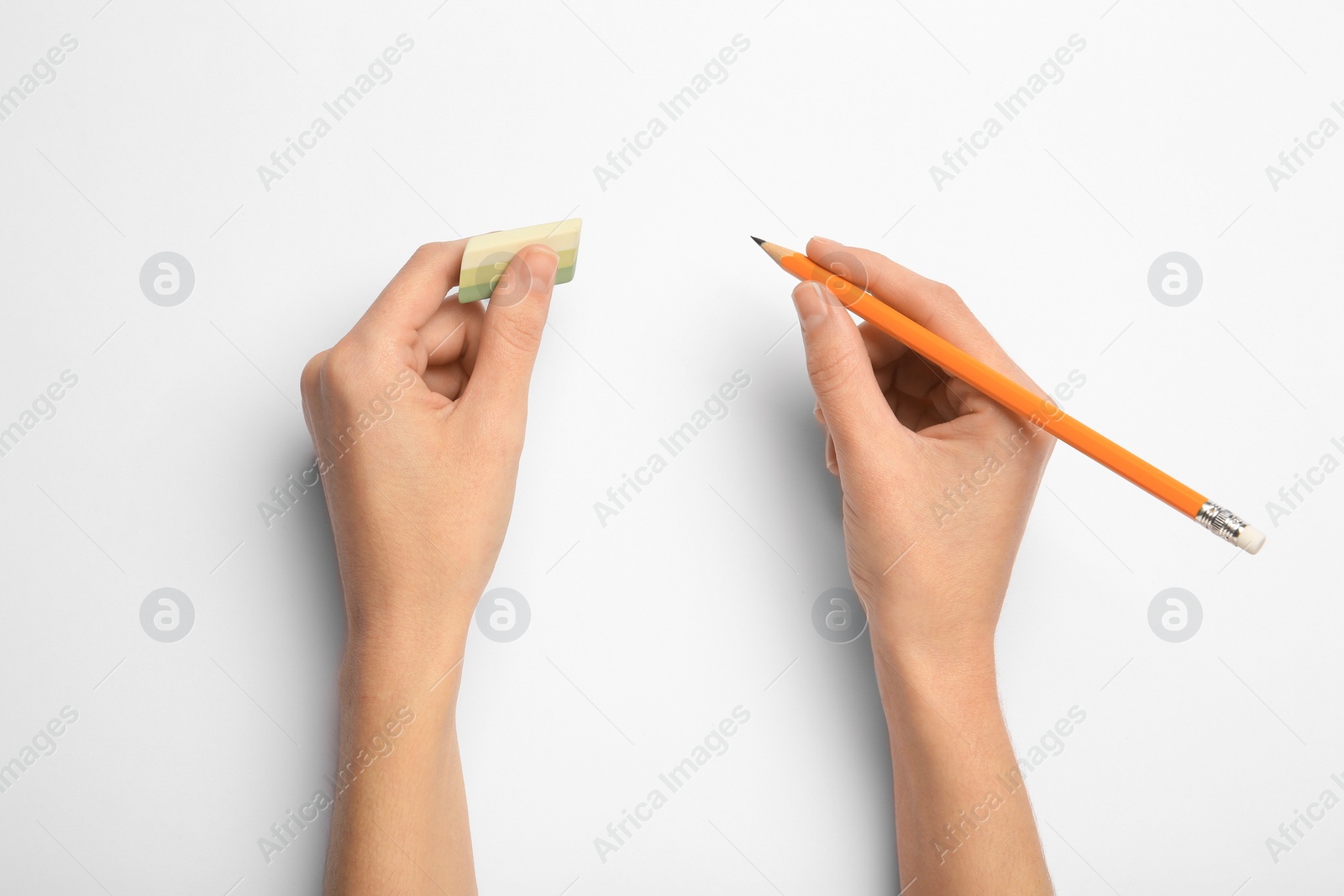 Photo of Woman with graphite pencil and eraser on white background, top view