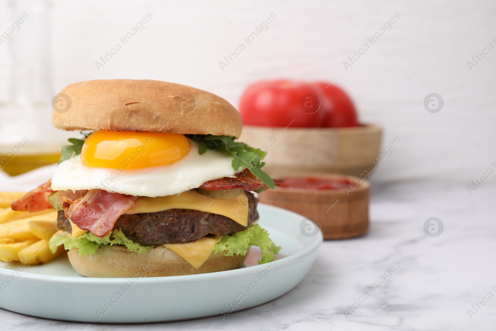 Photo of Delicious burger with fried egg and french fries served on white marble table, closeup. Space for text