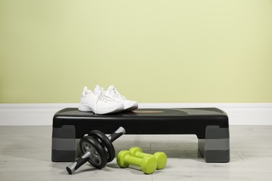 Photo of Step platform and different sports equipment indoors