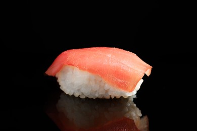Delicious nigiri sushi with tuna on black background