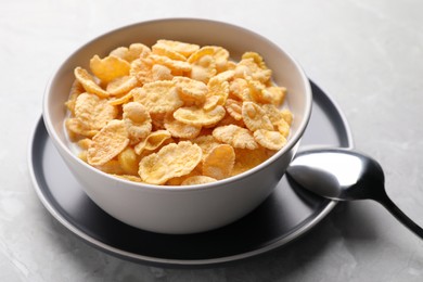 Photo of Tasty cornflakes with milk served light grey table