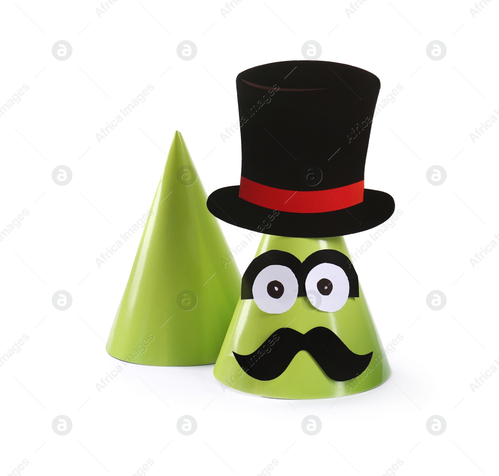 Photo of Handmade party hats with funny face isolated on white