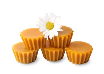 Photo of Natural beeswax cake blocks and flower on white background