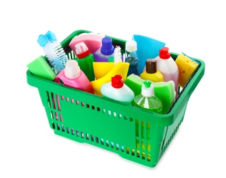 Photo of Green shopping basket with different household chemicals on white background