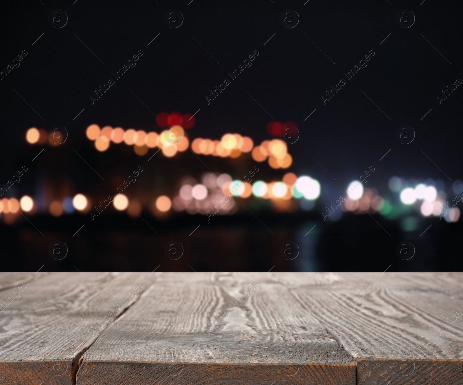 Image of Empty wooden surface against blurred lights. Bokeh effect 