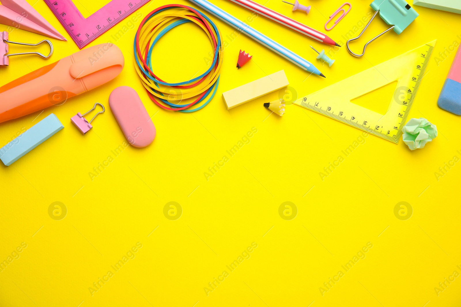 Photo of Flat lay composition with different school stationery on yellow background, space for text. Back to school