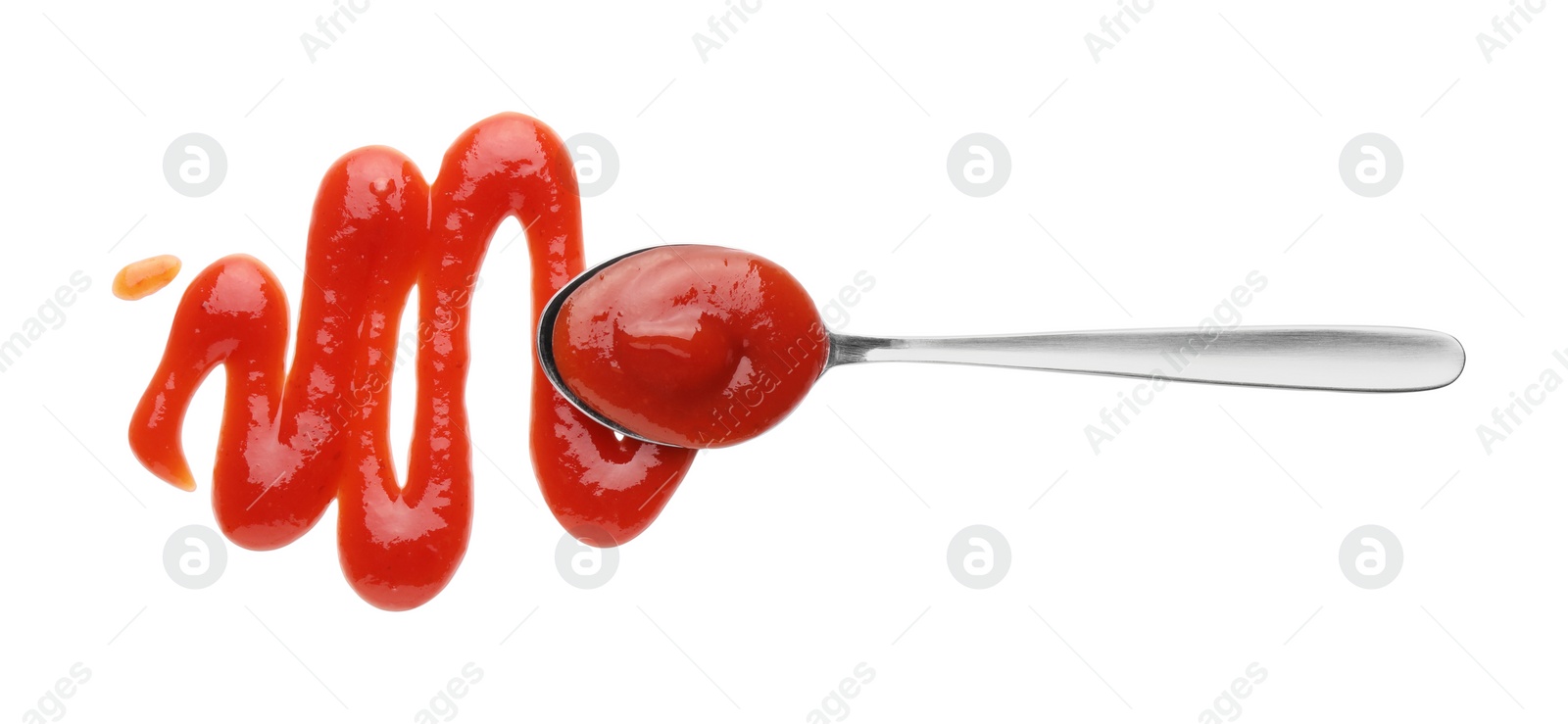 Photo of Tasty ketchup and spoon isolated on white, top view