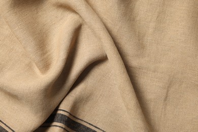 Texture of beige crumpled fabric as background, top view