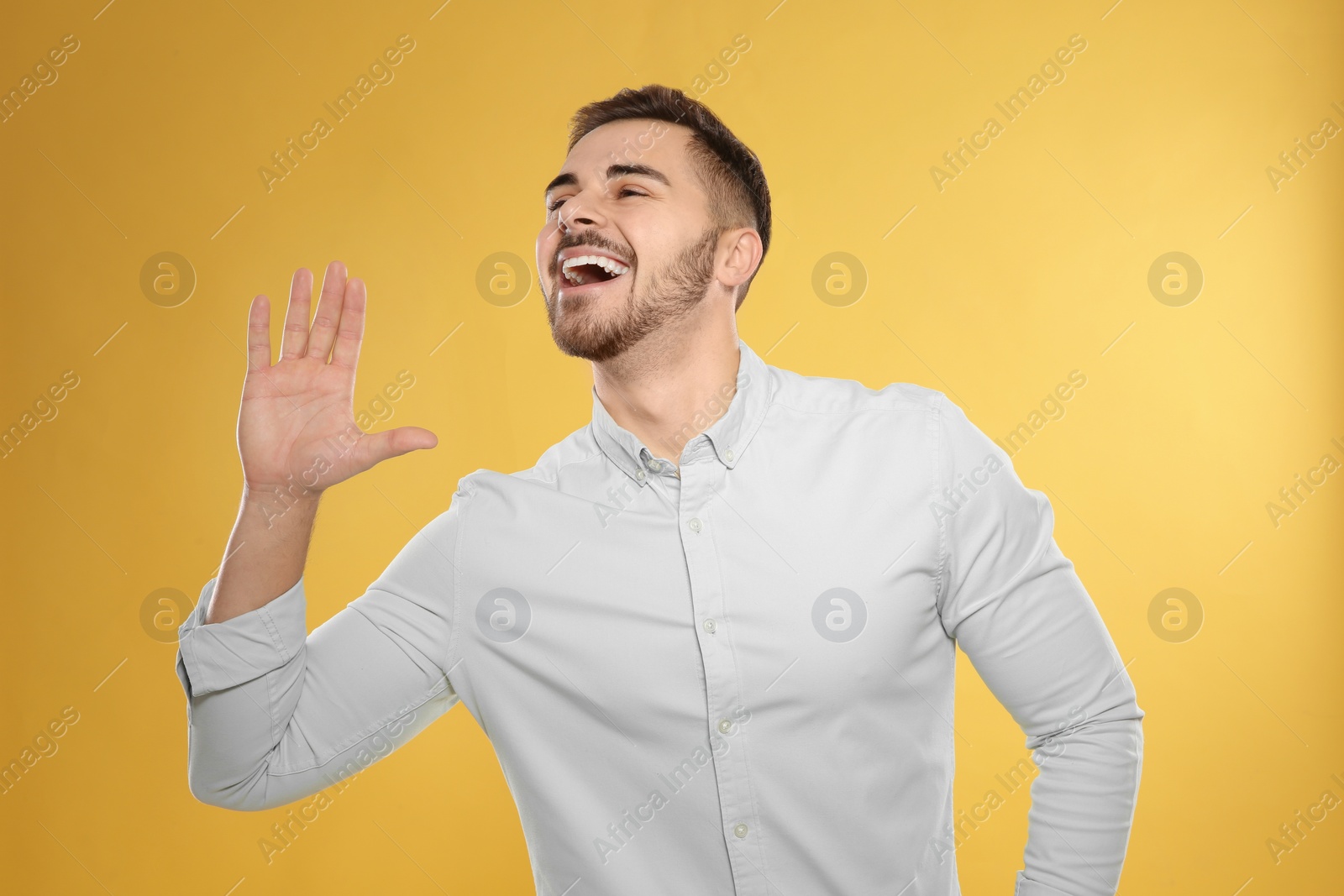 Photo of Portrait of handsome young man on color background