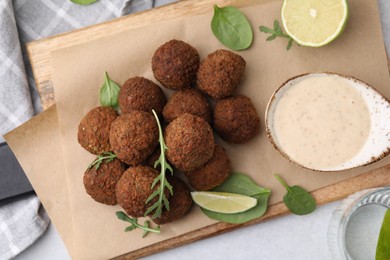 Photo of Delicious falafel balls served on light table, top view