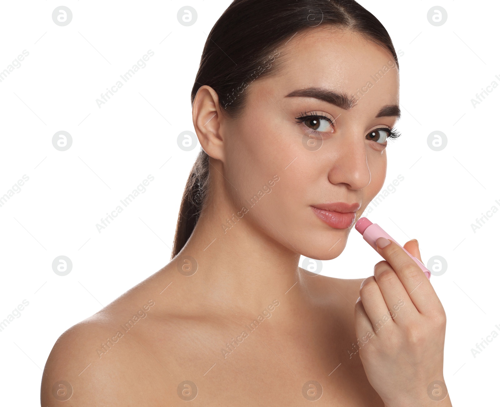 Photo of Young woman applying lip balm on white background