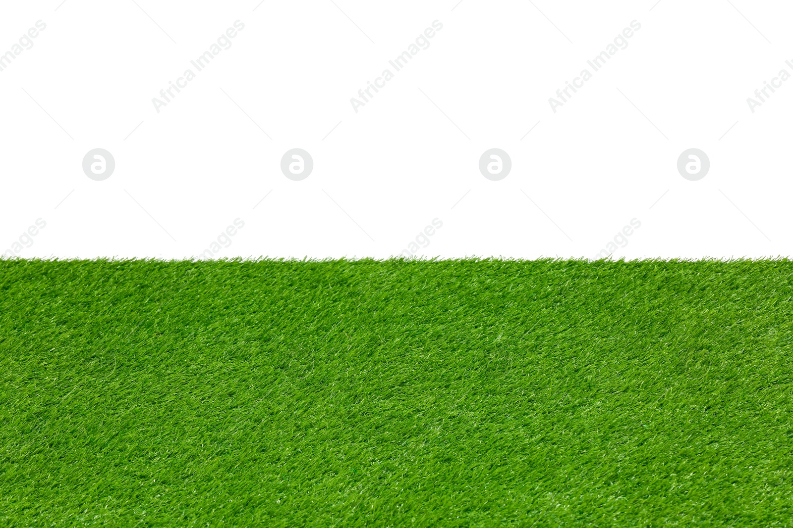 Photo of Green artificial grass surface isolated on white