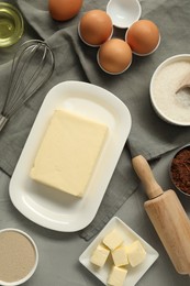 Photo of Flat lay composition with fresh butter and other products on grey table