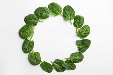 Frame made of spinach leaves on white background, top view. Space for text