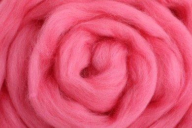 Pink felting wool as background, closeup view