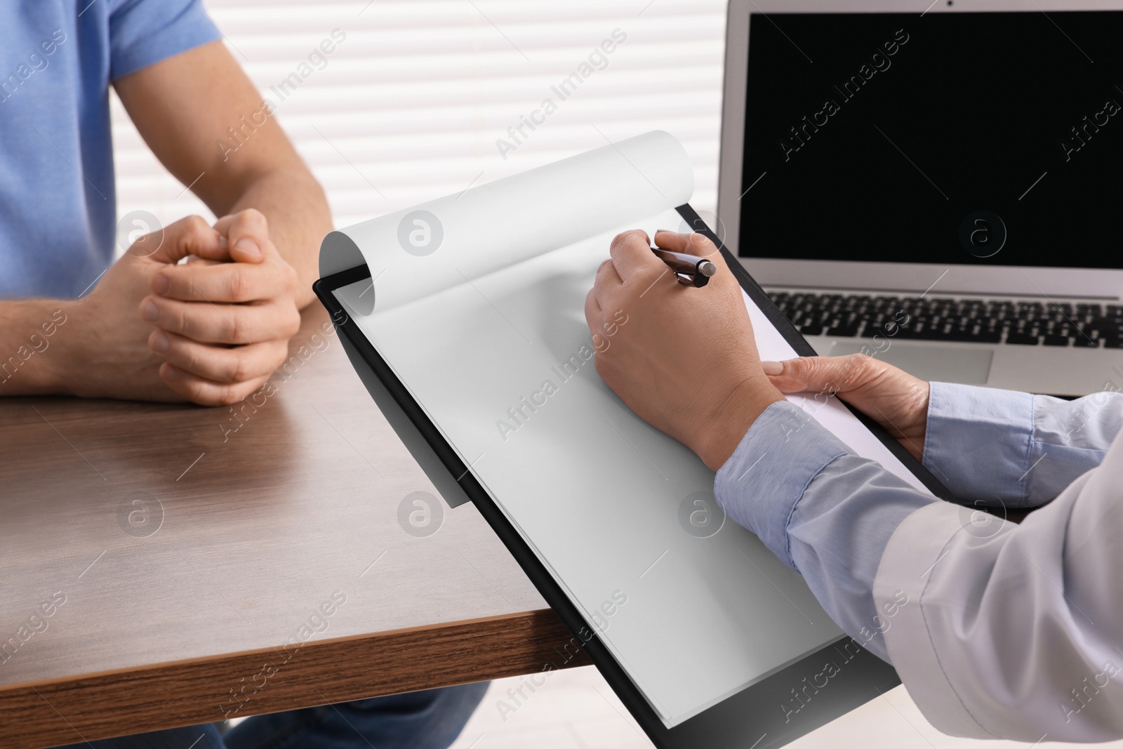 Photo of Doctor with clipboard in clinic, closeup. Patient consultation