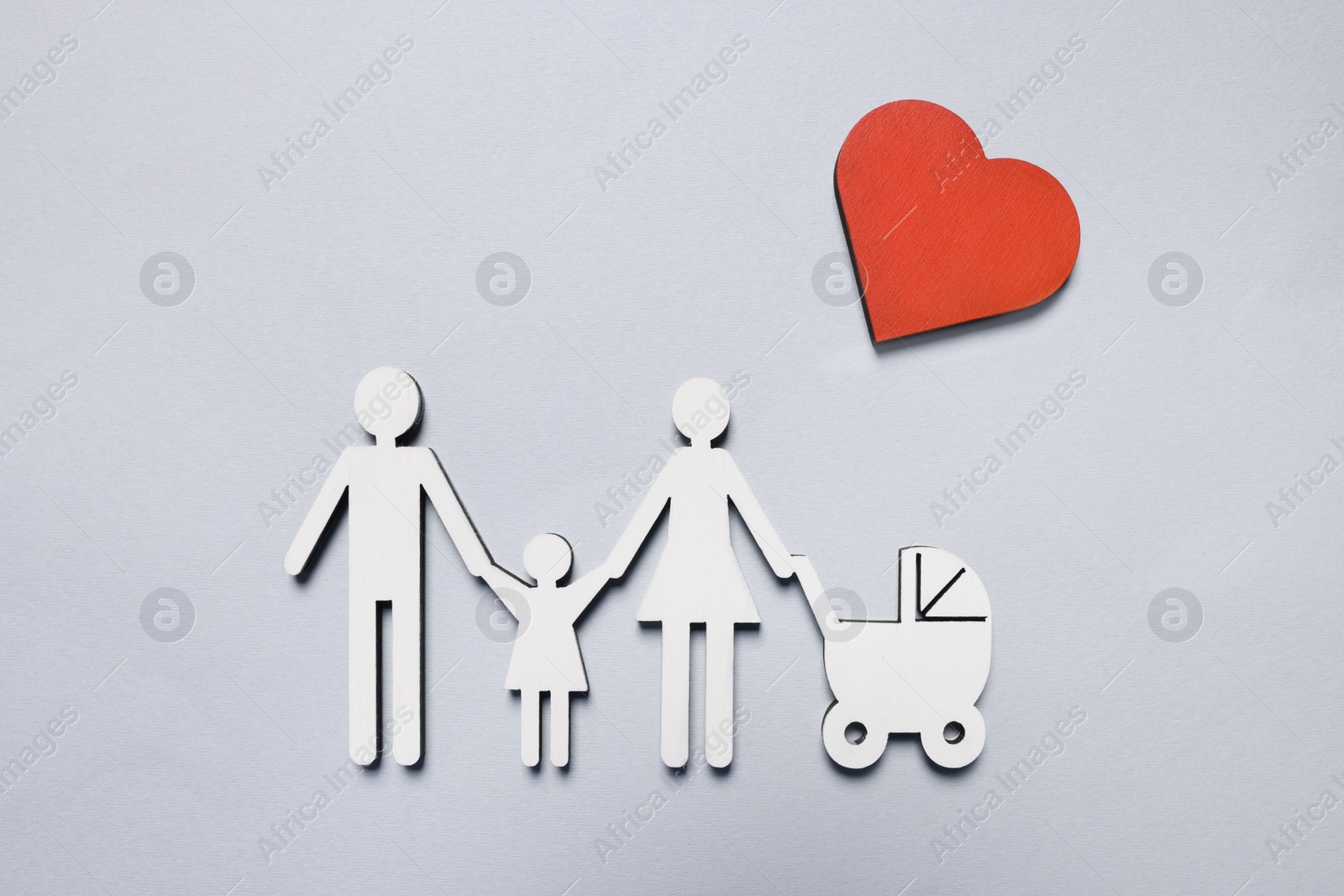 Photo of Figures of family and heart on light background, top view. Insurance concept