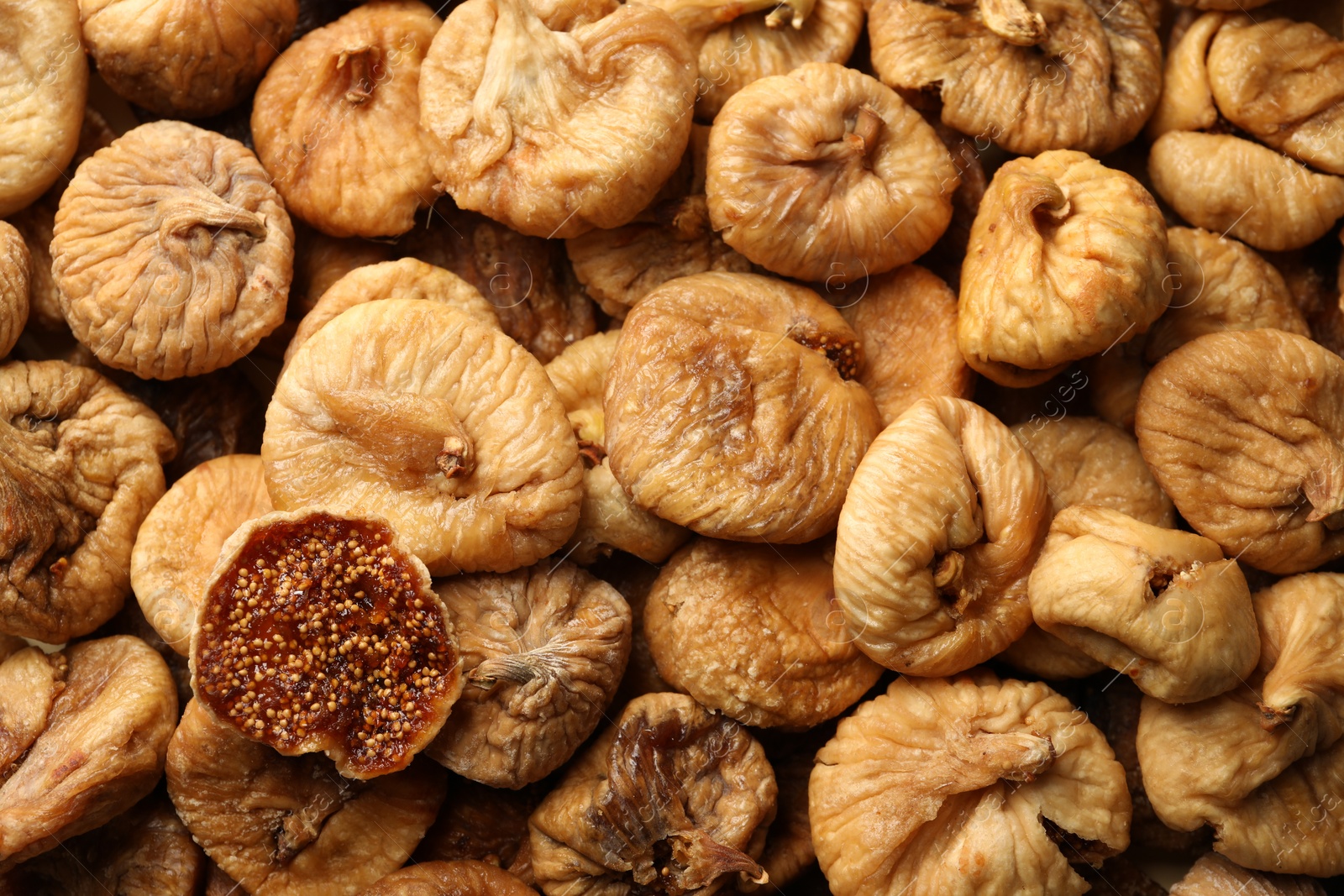 Photo of Many tasty dried figs as background, top view