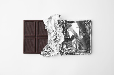 Photo of Tasty chocolate bar on white background, top view